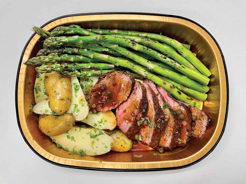 A Fitness Kitchen meal featuring steak with peppercorn sauce, asparagus and potatoes.