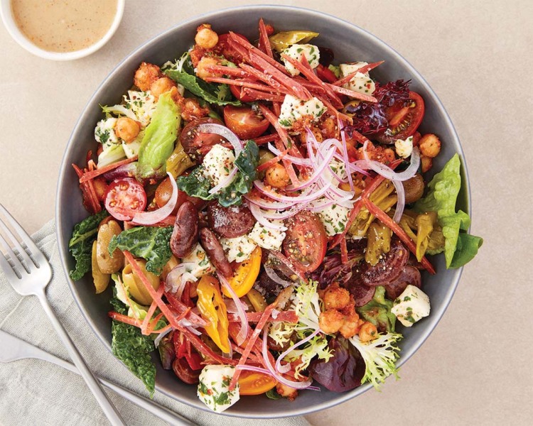 Goop Kitchen’s Suprema Chopped Salad with nitrate-free turkey salami, heirloom lima beans, olives, pickled shishitos, mozzarella, red onions, tomatoes and shallot vinaigrette.
