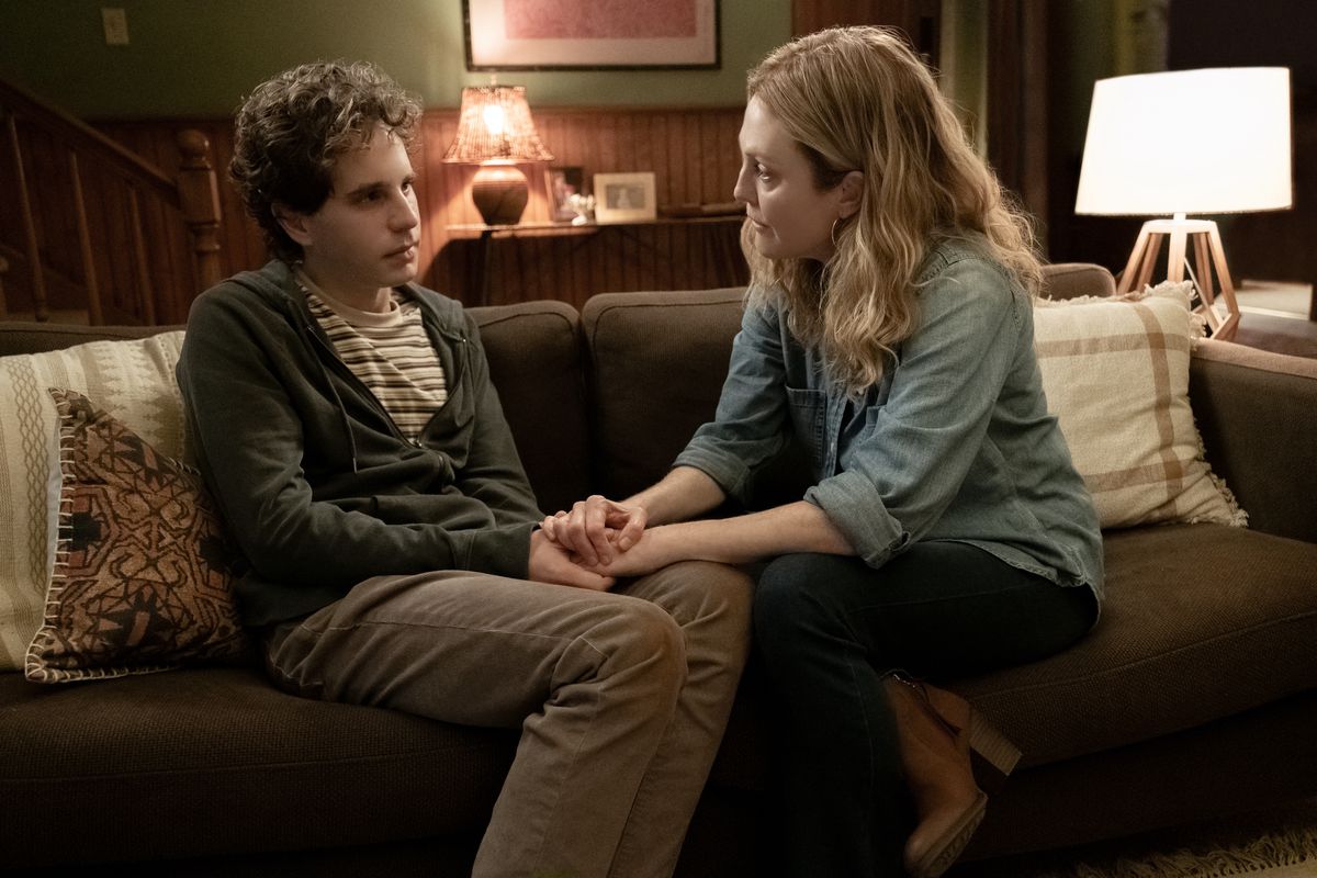 Evan and Evan’s mom sit on a couch in Dear Evan Hansen